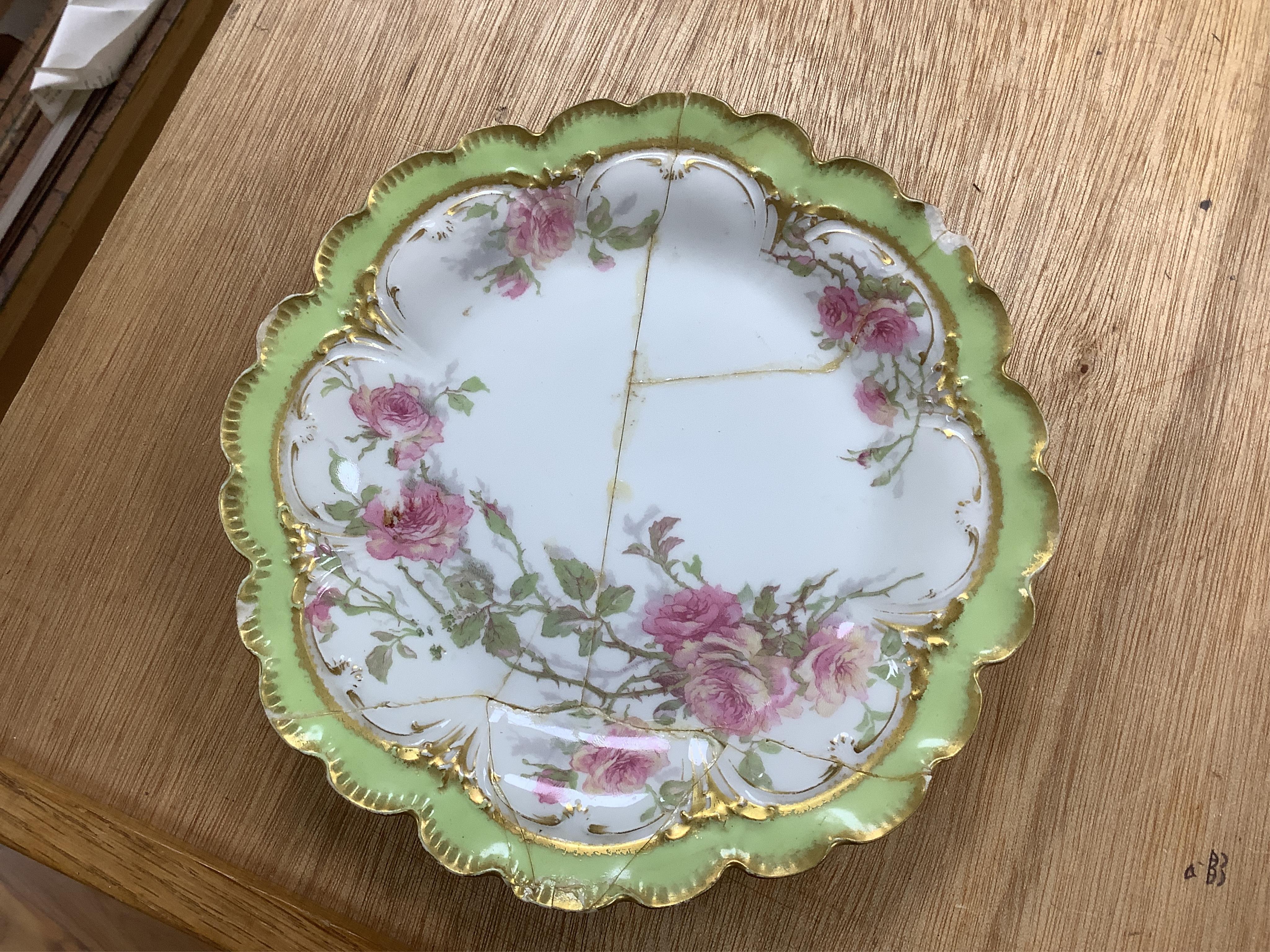 A French porcelain part dessert service together with a set of four Aynsley cups and saucers, the cups with silver holders. Condition - varies, some repairs